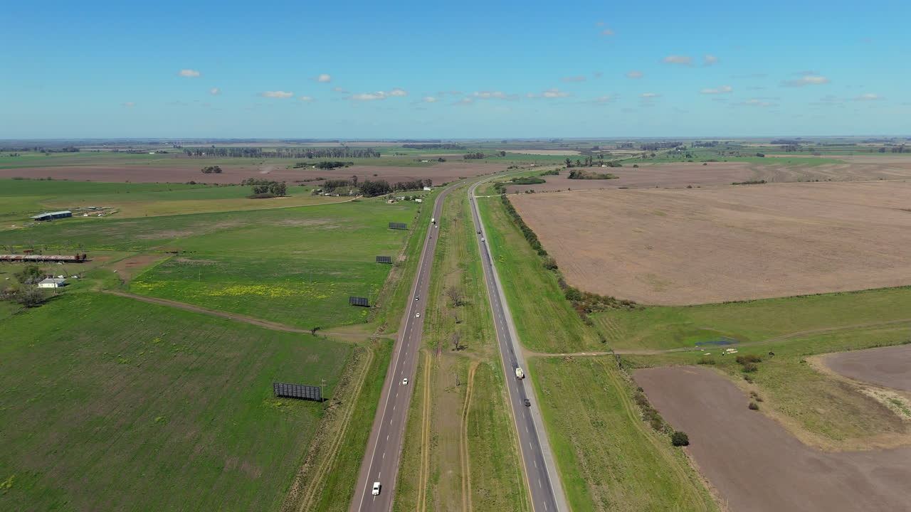 Aerial View of a Highway Cutting Through Vast Farmlands