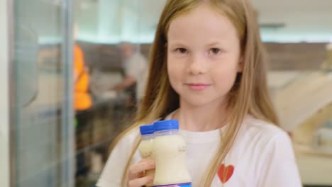 girl shopping for milk in a supermarket