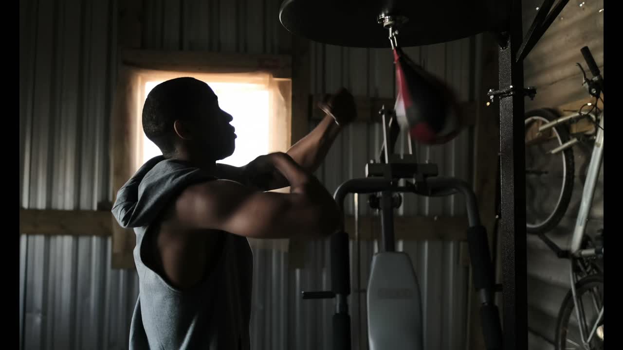 African American male boxer practicing boxing in fitness studio 4k