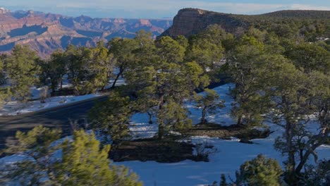 Campervan-Driving-Through-Mountain-Road-In-Grand-Canyon-National-Park-In-Arizona,-USA---aerial-shot