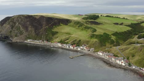 aerial view of the crovie village on the aberdeenshire coastline on an overcast summer evening