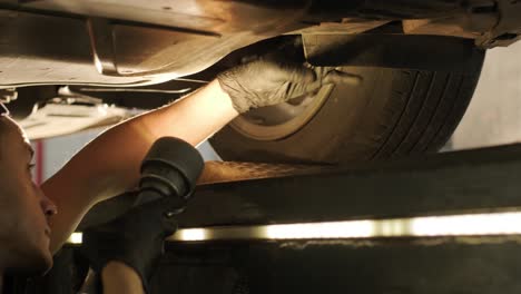 car suspension test at automobile service. inspection of the undercarriage of the car in the auto service. repair and maintenance of the car in service.