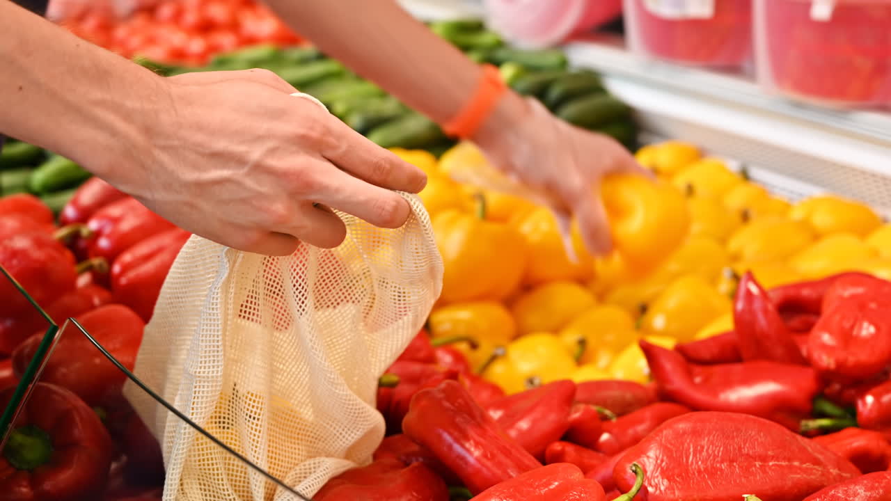 Man's hands putting papers in a reusable ecological bag in the supermarket. Ecology idea