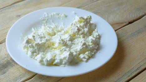 a man eats a spoonful of cottage cheese with sour cream