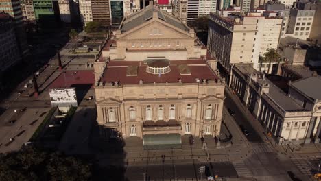 aerial tracking shot of ancient building of teatro colon lighting by sunlight - famous architecture for concert and opera shows in buenos aires