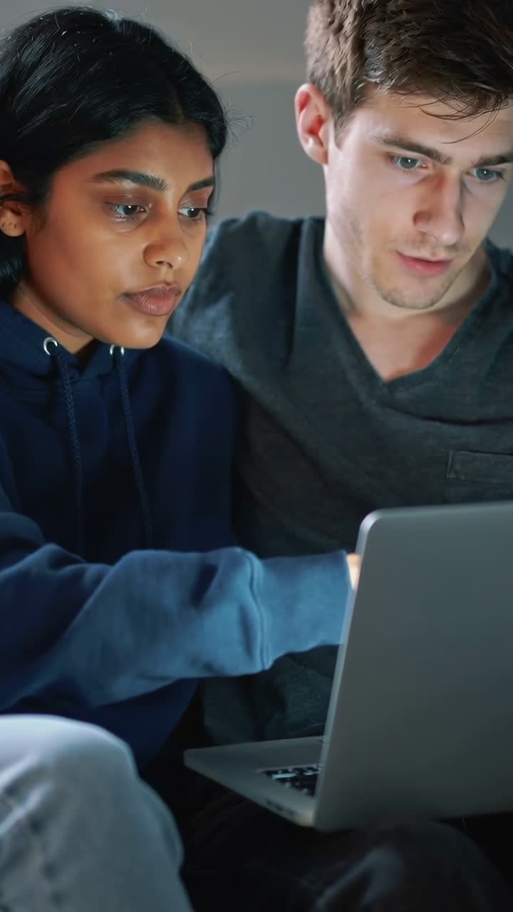 Young Couple Looking at Laptop Screen Together