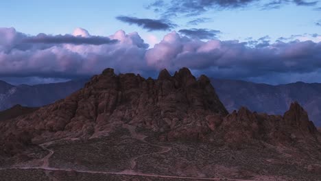 crashing a drone while backing out of an epic scene during sunset with some jagged mountains and colorful clouds