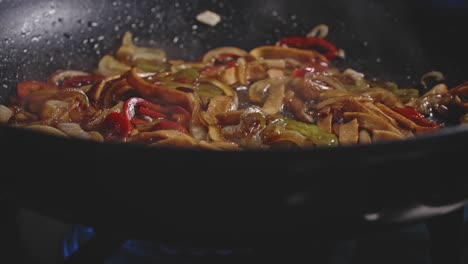 a close up looking into a skillet of steamy sauteed vegetables