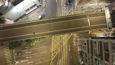 top down view of street network in hong kong with elevated road between old style high-rise buildings