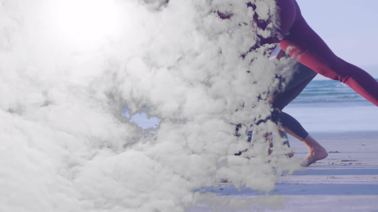 Running on beach with cloud animation overlay, people enjoying sunny day