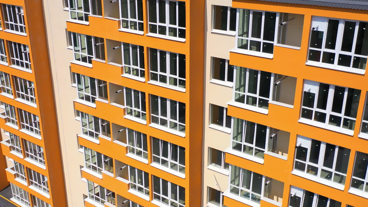 Exterior of an orange and beige apartment building
