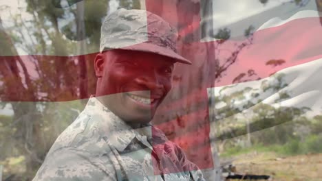 composición digital de agitar la bandera de inglaterra contra el retrato de un soldado sonriendo en el campamento de entrenamiento