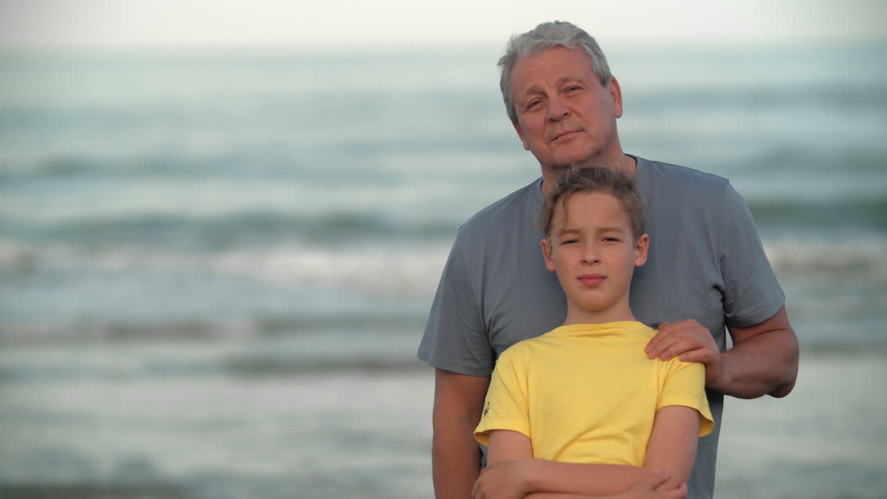 Adolescente com o avô à beira-mar.