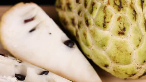 custard apple being sliced and displayed