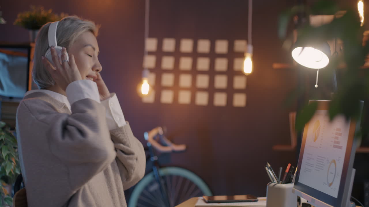 Woman Dancing to Music in the Office