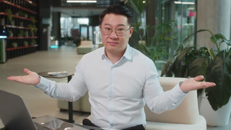 angry businessman raising hands in indignant expression asking reason of failure in office lobby