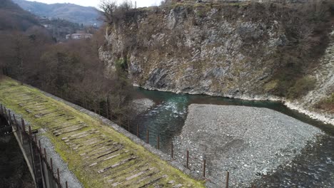 old bridge over a river in a mountain valley