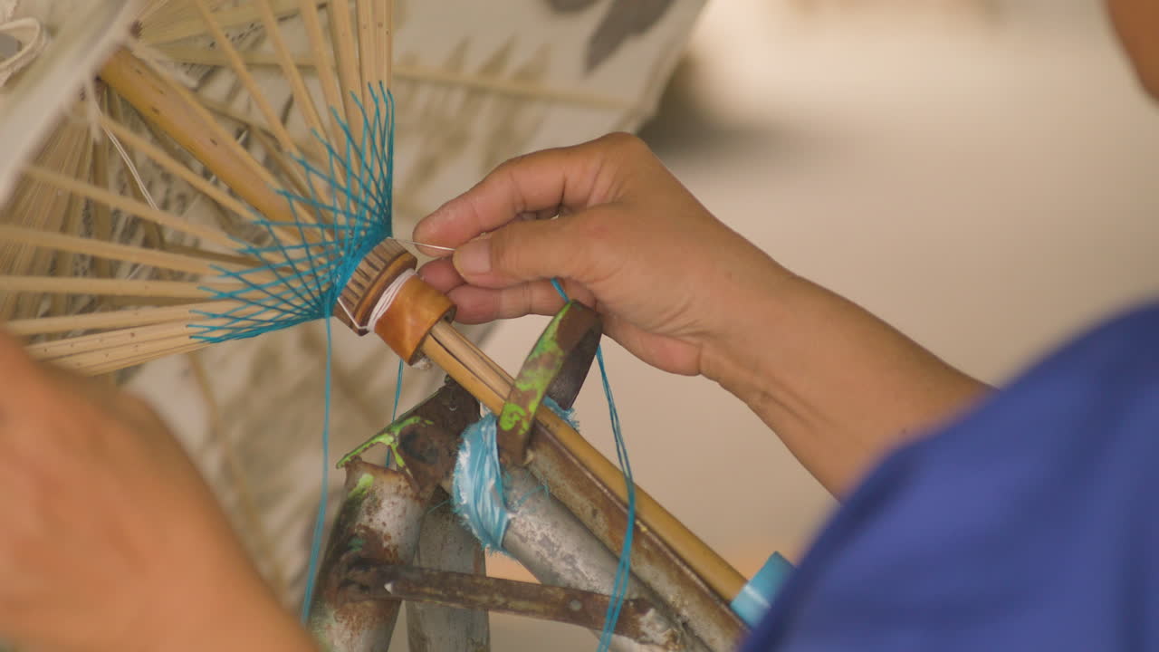 Cropped View Of A Woman Making Handmade Paper Umbrella At Bo Sang Near Chiang Mai, Thailand. Close-up Shot