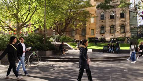 pedestrians walking outside state library of victoria