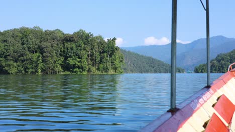 boat traversing a calm, picturesque lake