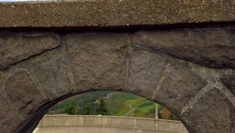 4K-Elevated-view-from-lighted-path-of-Columbia-River-trucking-back-through-archway-booming-up-to-reveal-same-view-with-mostly-cloudy-sky