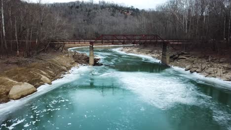 Push-In-Shot-of-Rusty-Old-Mountain-Footbridge-in-Winter