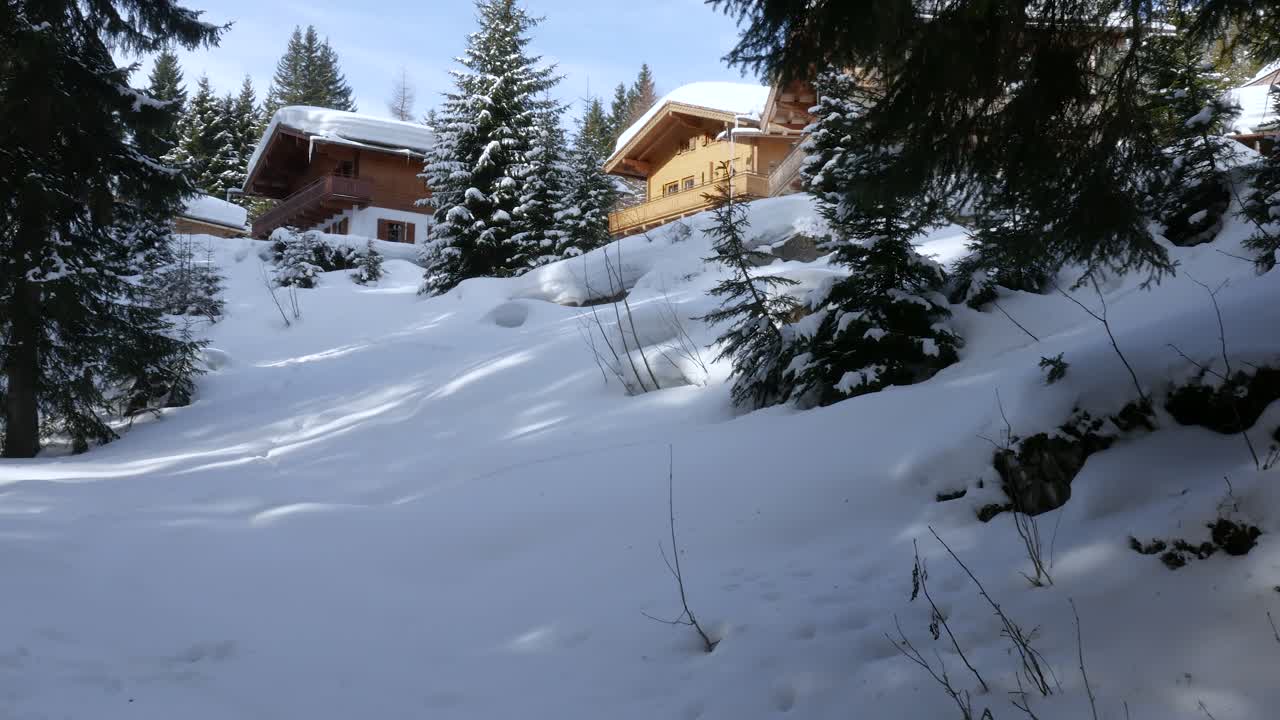 Snowy Winter Landscape with Wooden Cabins in the Mountains