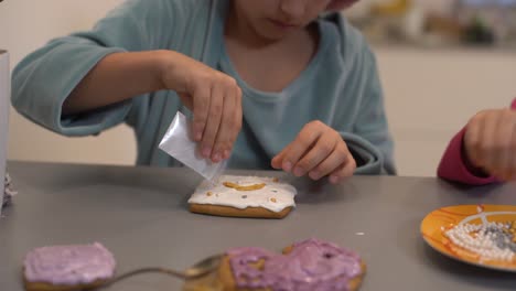 girl decorates homemade gingerbread for easter