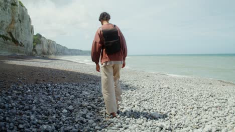 woman hiking on a rocky beach