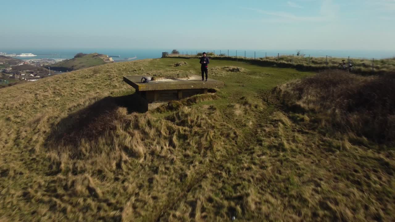 Hillside view with ocean and person