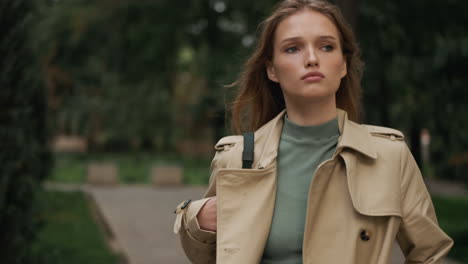 caucasian female student walking outdoors.