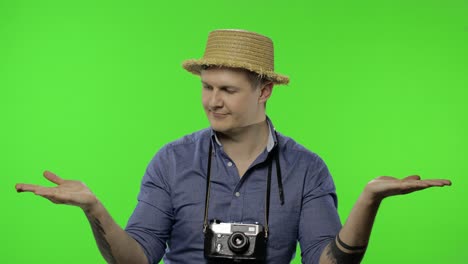 portrait of young man tourist photographer pointing at something. chroma key