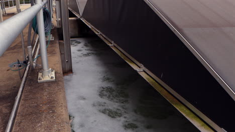 wastewater churns in a uv-filter aeration basin, bubbles rising and rippling as the water is actively treated and purified