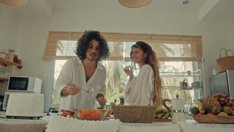 couple cooking together in a tropical kitchen