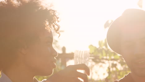 Friends-drinking-on-Brooklyn-rooftop,-handheld-close-up-pan