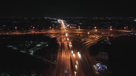 car traffic transportation on highway road intersection in bangkok city, thailand at night. public transport, commuter lifestyle, asian city life concept. drone aerial high angle view