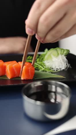 salmon sashimi with chopsticks