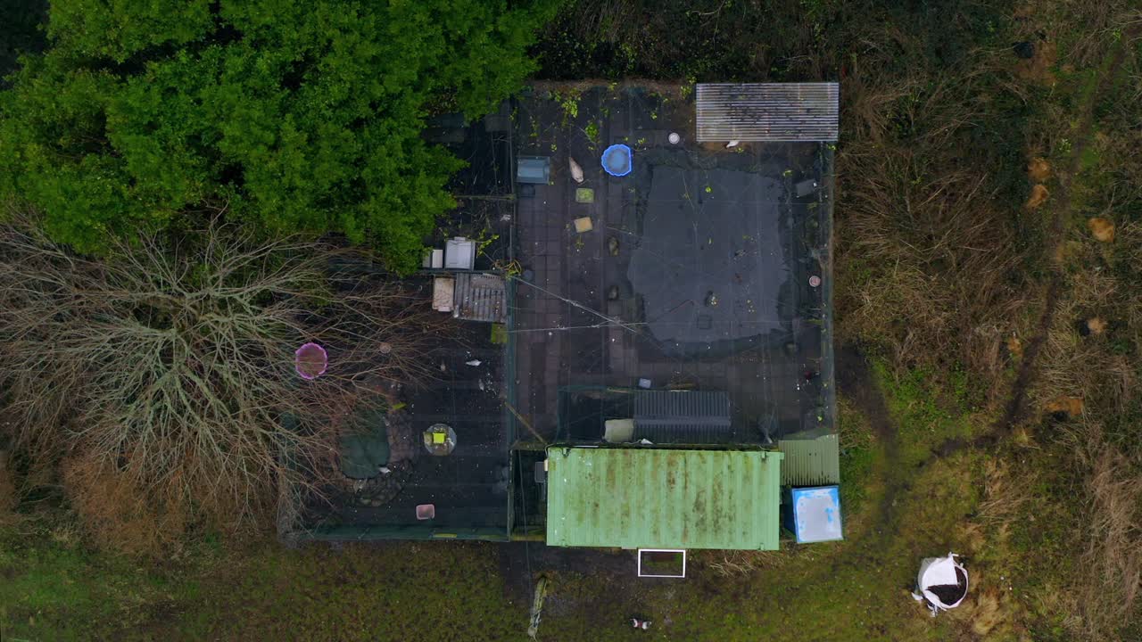 Symmetric top-down aerial ascending over Galway And Claddagh Swan Sanctuary, showing enclosures