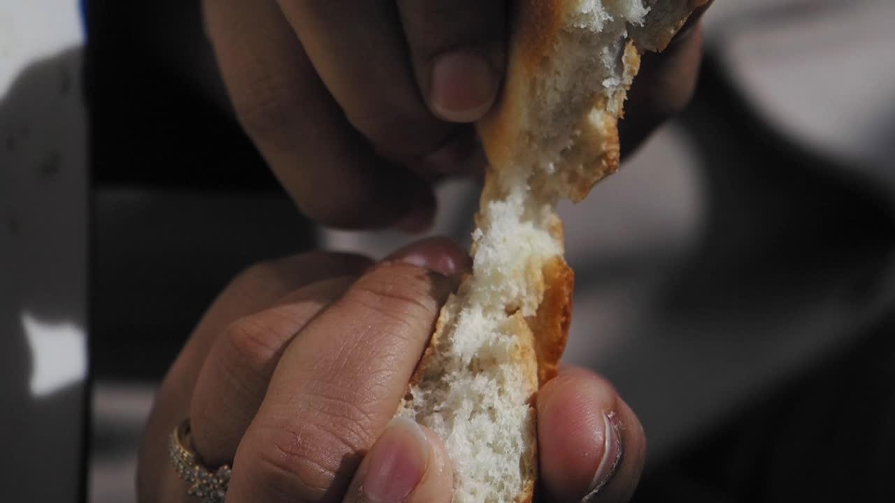 Person tearing bread