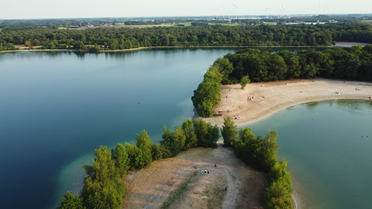 Aerial View of Lakeside Beach with People Relaxing