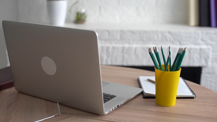 Office workplace with notebook on wood table.