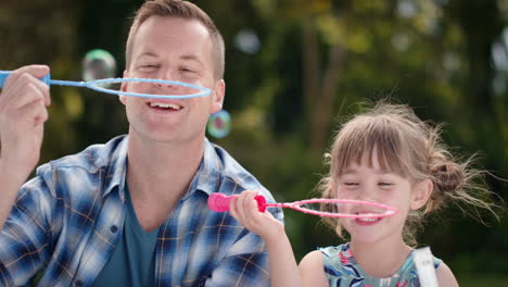 father-and-daughter-blowing-soap-bubbles-together-in-sunny-park-happy-little-girl-having-fun-dad-playing-with-child-playfully-enjoying-summer-4k