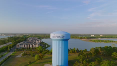 Aerial-establishing-shot-over-buildings-and-main-highway-with-water-tower,-Sarasota,-Florida