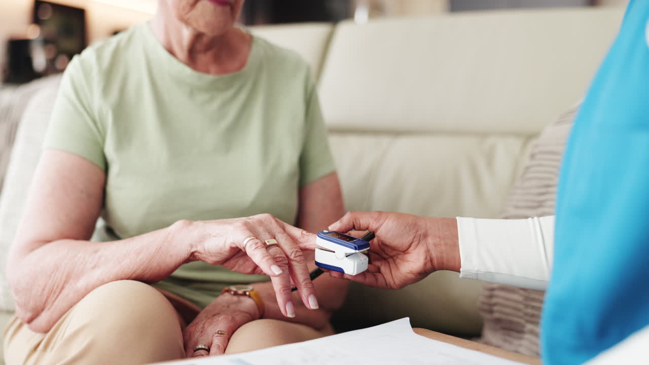 Healthcare Professional Using Pulse Oximeter on Elderly Woman's Finger