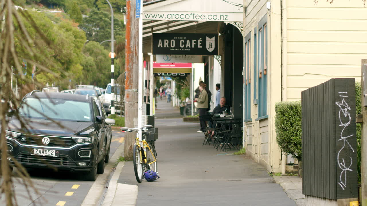 Looking down a footpath in Aro Valley with a cafe in Wellington, New Zealand