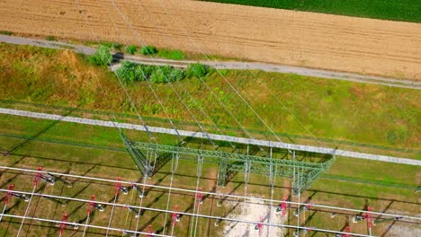 electrical transformer substation in green fields - aerial top down