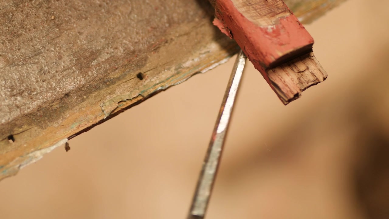 Chiseling old glue edge of wood boat hull plank
