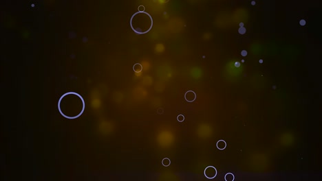 las partículas bokeh flotan y brillan sobre un fondo oscuro con profundidad de campo.