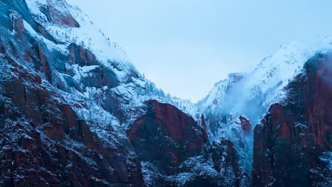 Close-up-of-2-mountain-peaks-in-Zion-national-park-while-its-windy-and-snowing