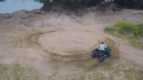 quad motor driving in a circle. one man driving quad motor in a circle.